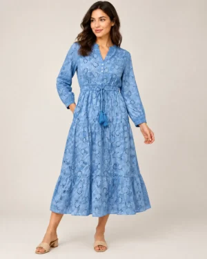Blue midi dress with allover eyelet cutout pattern, long sleeves, button front, and drawstring waist with tassels.